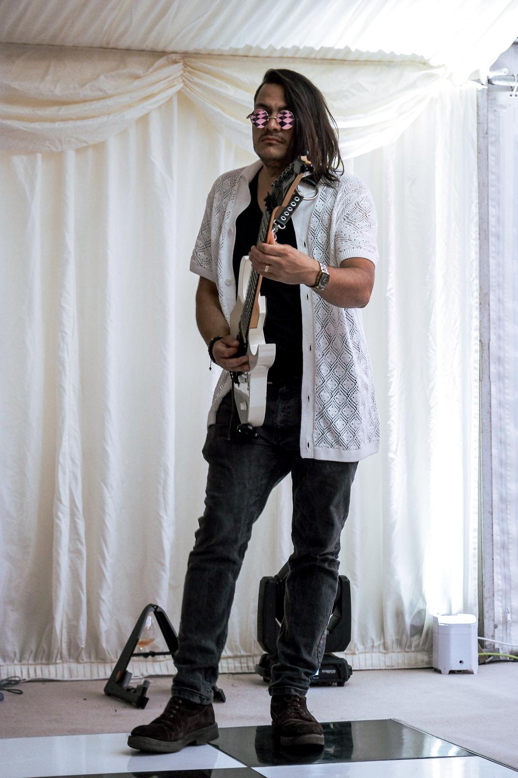 Guitarist performing at a marquee event