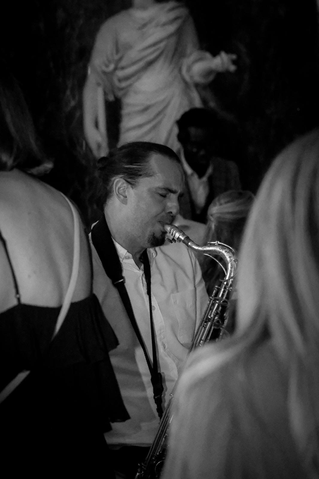 Saxophonist performing at an evening event